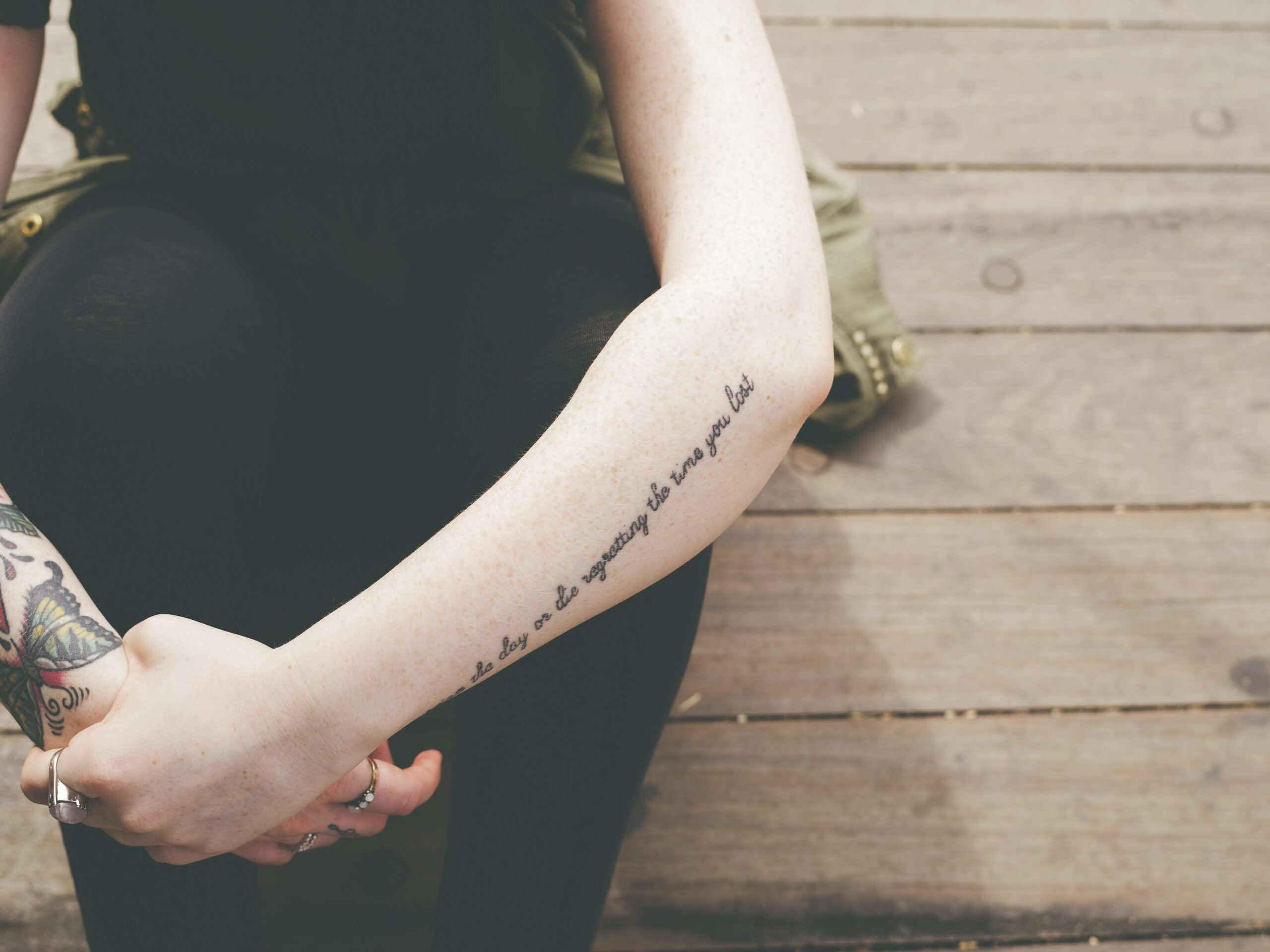 an artistic photo of a young woman's tattoos on her arms